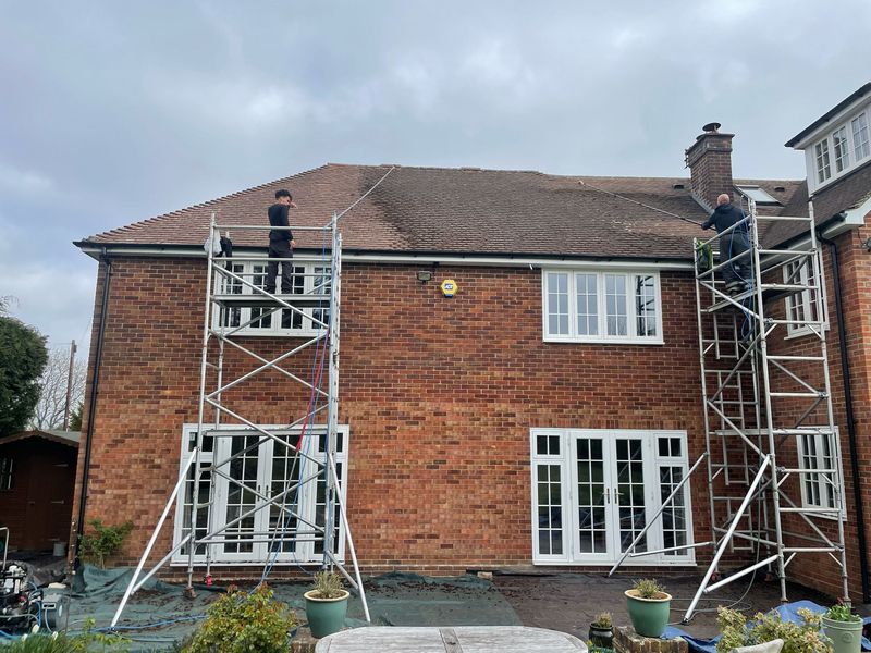 Roof cleaning carried out safely from scaffold towers by The Roof Moss Cleaners in Toddington